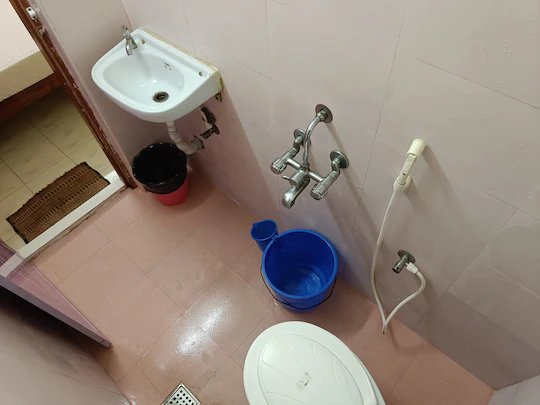 Attached bathroom with wash basin and shower