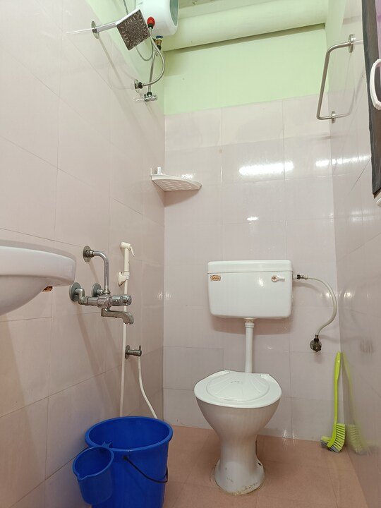 Clean attached bathroom with water heater